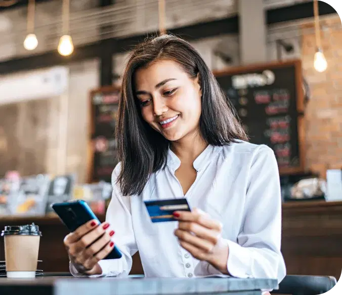 A woman holding a card and smiling