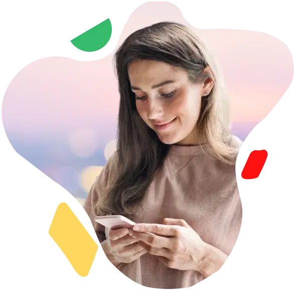 A woman holding a card and smiling
