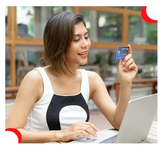 A woman holding a card and smiling